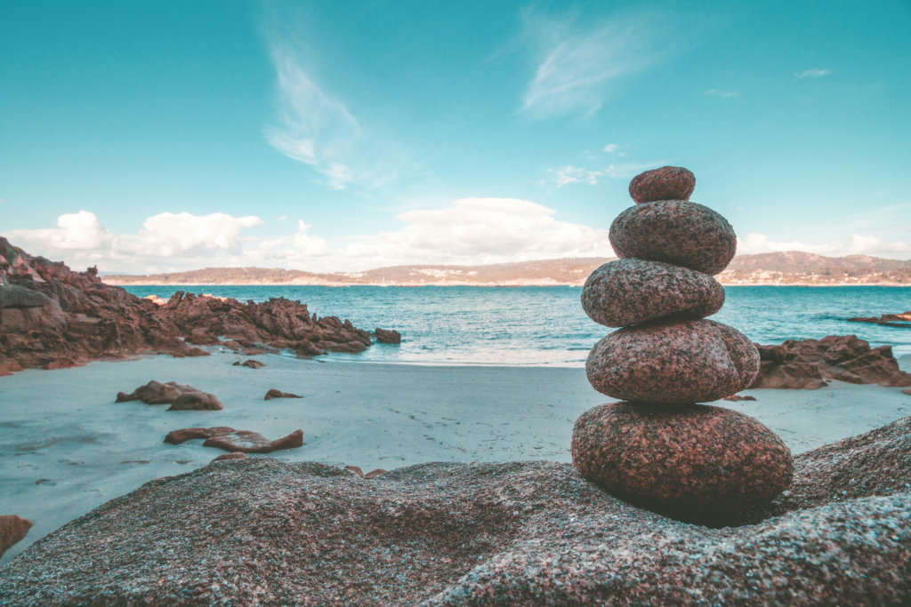 Stacked stones by the sea symbolising balance and calm in mindfulness practice