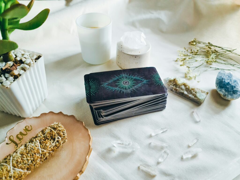 A calm tarot reading setup with crystals, candles, and a deck of cards, reflecting the spiritual meaning of tarot cards and intuitive guidance.