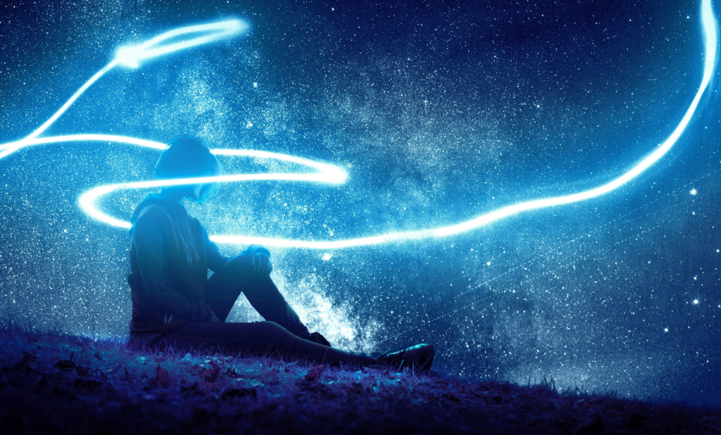Abstract depiction of the spiritual meaning of dreams, showing a person surrounded by flowing light energy beneath a star-filled cosmic sky