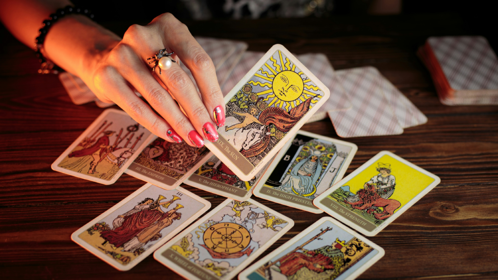 A hand selecting a tarot card from a traditional spread, symbolising intuition, symbolism, and spiritual insight.