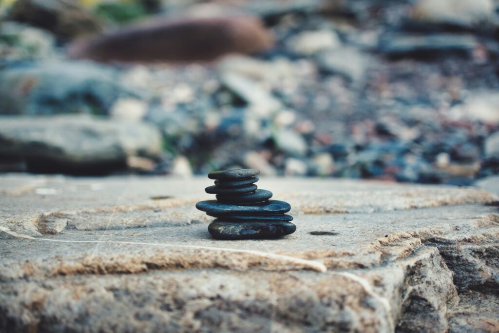 Stacked stones on a natural surface symbolising balance, calm, and inner stillness through meditation benefits and practices.